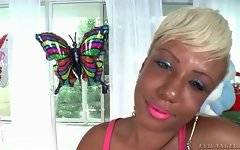 Pretty black tranny with short blond hair fleshes her tits.