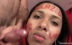 Horny dude sprays cum on his t-girlfriend`s cute face.